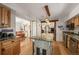 Bright kitchen with hardwood floors, center island with granite countertop, and stainless steel appliances at 27802 Shadow Mountain Dr, Conifer, CO 80433
