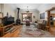 Comfortable living room with a wood-burning stove, hardwood floors, and cozy decor at 27802 Shadow Mountain Dr, Conifer, CO 80433