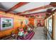 Inviting covered porch with wooden beams, rocking chairs, and mountain decor at 27802 Shadow Mountain Dr, Conifer, CO 80433