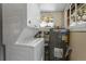 Functional utility room with stacked washer and dryer and a large water heater at 27802 Shadow Mountain Dr, Conifer, CO 80433