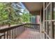 View from the wooden balcony with a view of surrounding trees and green landscape at 4843 Silver Spruce Ln, Evergreen, CO 80439