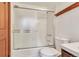 This bathroom has a shower and bath tub combination with a frosted sliding door and ample space at 4843 Silver Spruce Ln, Evergreen, CO 80439