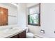 Bright bathroom boasts a large window with scenic views, classic vanity, and a clean, functional layout at 4843 Silver Spruce Ln, Evergreen, CO 80439