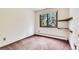 Standard bedroom featuring a window with trees, and shelving on the right at 4843 Silver Spruce Ln, Evergreen, CO 80439