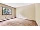 Standard bright bedroom featuring a window with a view of trees outside at 4843 Silver Spruce Ln, Evergreen, CO 80439