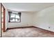 A bright bedroom featuring a window with curtains and view of neighborhood at 4843 Silver Spruce Ln, Evergreen, CO 80439