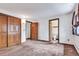 Bright bedroom with closet, brown carpet, and entryways to other rooms at 4843 Silver Spruce Ln, Evergreen, CO 80439