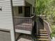 View of the house deck featuring wood railings and steps leading to the ground at 4843 Silver Spruce Ln, Evergreen, CO 80439
