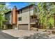 Charming multi-level home featuring an attached garage, a chimney and a cozy second-floor balcony at 4843 Silver Spruce Ln, Evergreen, CO 80439