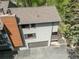 Aerial view of the multi-level home featuring an attached garage and a cozy second-floor balcony at 4843 Silver Spruce Ln, Evergreen, CO 80439