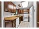 Traditional kitchen with wooden cabinets, appliances, tile floor, and ample natural light at 4843 Silver Spruce Ln, Evergreen, CO 80439
