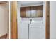 Convenient laundry area with washer and dryer hookups, overhead storage, and easy access at 4843 Silver Spruce Ln, Evergreen, CO 80439
