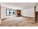 Spacious living room features a stone fireplace, carpeted floors, and large windows for ample natural light at 4843 Silver Spruce Ln, Evergreen, CO 80439
