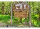 Entrance to Silver Spruce Village, a covenant community surrounded by lush greenery at 4843 Silver Spruce Ln, Evergreen, CO 80439