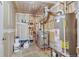 Exposed utility room perfect for storage, with plumbing, water heater, and electric panel at 4843 Silver Spruce Ln, Evergreen, CO 80439