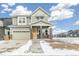 Charming two-story home featuring a covered porch and a two-car garage at 21025 E 61St Dr, Aurora, CO 80019