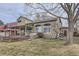 Charming backyard featuring a cozy covered deck, large windows, mature trees, and a well maintained lawn at 1525 E 133Rd Ave, Thornton, CO 80241