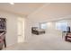 Open basement featuring carpeted floors, bedroom area, windows, and a door to a private bathroom at 1525 E 133Rd Ave, Thornton, CO 80241
