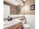 Cozy bathroom featuring tile wainscoting, neutral paint, and modern sink at 1525 E 133Rd Ave, Thornton, CO 80241