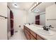 A spacious bathroom features double sinks with wood cabinets, and a shower with a stylish curtain at 1525 E 133Rd Ave, Thornton, CO 80241