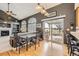 Open dining area features hardwood floors, modern light fixtures, and access to an outdoor deck at 1525 E 133Rd Ave, Thornton, CO 80241