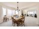 Bright dining room with natural light, wooden table and chairs, ideal for Gathering meals at 1525 E 133Rd Ave, Thornton, CO 80241