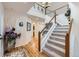 Bright foyer with staircase, chandelier, and hardwood floors, creating an elegant entrance at 1525 E 133Rd Ave, Thornton, CO 80241