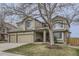 Traditional two-story home featuring a three-car garage, covered porch, and a well-manicured front lawn at 1525 E 133Rd Ave, Thornton, CO 80241