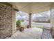 Spacious front porch with brick columns, creating a comfortable outdoor space at 1525 E 133Rd Ave, Thornton, CO 80241
