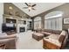 Spacious living room with vaulted ceiling, fireplace, and built-in shelving at 1525 E 133Rd Ave, Thornton, CO 80241