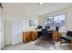 Bright office with natural light, wood desk, and cozy chair at 1525 E 133Rd Ave, Thornton, CO 80241