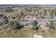 Bird's eye view of home, highlighting its location near the golf course, mature trees and landscaping at 26 Wedge Way, Littleton, CO 80123