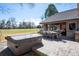Outdoor back patio featuring a hot tub, ample seating, and views of the lush green backyard at 26 Wedge Way, Littleton, CO 80123