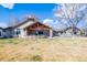Spacious backyard featuring a covered patio, perfect for enjoying outdoor living and entertaining at 26 Wedge Way, Littleton, CO 80123
