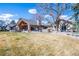 Expansive backyard with covered patio, fire pit, and hot tub, perfect for outdoor relaxation and entertaining at 26 Wedge Way, Littleton, CO 80123