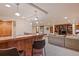 Finished basement boasts a wet bar with granite counters, wood cabinets, and a cozy adjacent seating area at 26 Wedge Way, Littleton, CO 80123