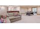 Relax in the large basement seating area, also featuring a wet bar and ping pong table at 26 Wedge Way, Littleton, CO 80123