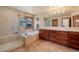 Bright bathroom with double vanity, tub, and glass shower at 26 Wedge Way, Littleton, CO 80123