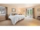 Serene bedroom with ample natural light, a cozy atmosphere, and direct access to the outdoors at 26 Wedge Way, Littleton, CO 80123