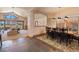 Bright dining room boasts natural light, a large wood table with seating for eight, and a view to the living area at 26 Wedge Way, Littleton, CO 80123