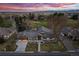 Sprawling home with mature landscaping, a tile roof, and an attached two-car garage near a golf course at 26 Wedge Way, Littleton, CO 80123