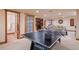 Spacious game room featuring a Brunswick ping pong table with access to a full bathroom, perfect for entertainment at 26 Wedge Way, Littleton, CO 80123