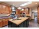 Well-equipped kitchen featuring an island, stainless steel hood, custom cabinets, and a skylight at 26 Wedge Way, Littleton, CO 80123
