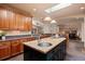 Spacious kitchen featuring an island with seating, custom cabinets, and views of the adjacent living spaces at 26 Wedge Way, Littleton, CO 80123