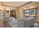 Welcoming living room with oversized window, tray ceiling, neutral decor, and an open floor plan at 26 Wedge Way, Littleton, CO 80123