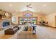 Inviting living room featuring a stone fireplace, vaulted ceilings, plush seating, and large windows at 26 Wedge Way, Littleton, CO 80123
