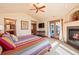 Sun-filled main bedroom features a fireplace, vaulted ceilings, patio access, and ensuite bathroom at 26 Wedge Way, Littleton, CO 80123