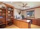 Warm office featuring wood built-ins, desk, and ample storage space with a view to the outdoors at 26 Wedge Way, Littleton, CO 80123