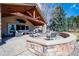 Backyard patio with stone outdoor fireplace and seating for entertaining with great backyard views at 26 Wedge Way, Littleton, CO 80123