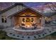 An outdoor patio with a seating area and fireplace, perfect for entertaining friends and Gathering at 26 Wedge Way, Littleton, CO 80123